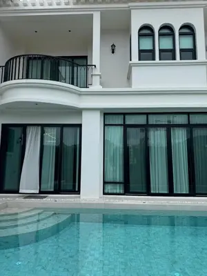 a house with a swimming pool in front of a house at Вилла на Бангтао in Ban Thalat Choeng Thale