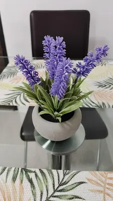 a vase with purple flowers on a table at No 498 SPD in Phuket Town