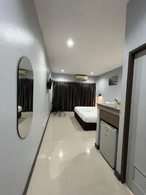 a hotel room with a bed and a mirror at PMS Guest House Patong in Patong Beach