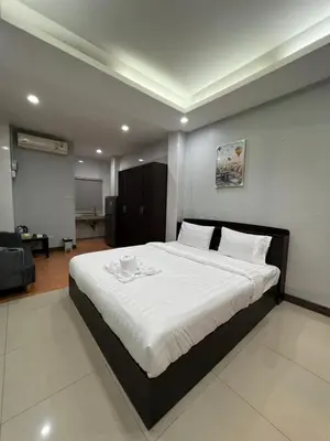 a bedroom with a large white bed in a room at PMS Guest House Patong in Patong Beach