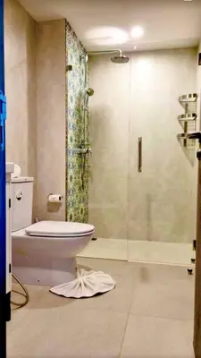 a bathroom with a toilet and a glass shower at naiyang beach in Phuket