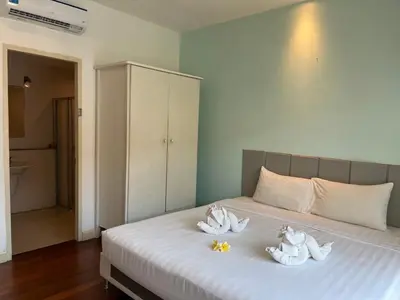 a bedroom with a bed with towels on it at Kata beach at pool house in Kata Beach
