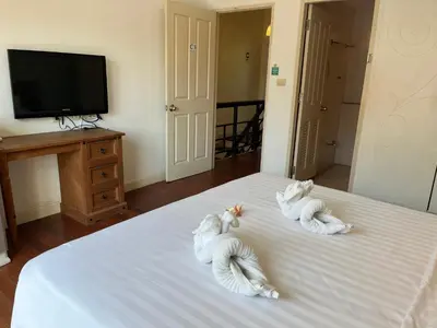 two stuffed animals on top of a bed at Kata beach at pool house in Kata Beach