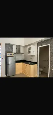 a kitchen with a sink and a refrigerator in it at Kata beach at pool house in Kata Beach