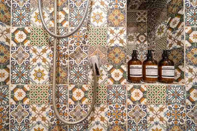 two bottles of wine on a tiled wall at 1BR Designer Mountain View Condo - Central Phuket in Phuket Town