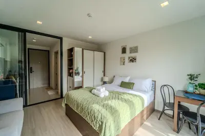 a bedroom with a bed with a teddy bear on it at 1BR Designer Mountain View Condo - Central Phuket in Phuket Town
