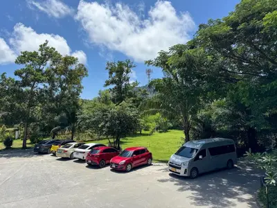 a row of cars parked in a parking lot at Kamala City Gate 1 Bdr Pool View in Kamala Beach