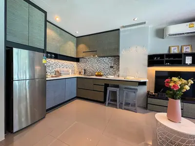 a large kitchen with a refrigerator and a counter at Kamala City Gate 1 Bdr Pool View in Kamala Beach