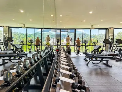a gym with a bunch of people exercising in it at Kamala City Gate 1 Bdr Pool View in Kamala Beach