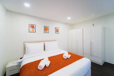 a bedroom with a bed with two stuffed animals on it at Stylish 3 Bedroom Villa with Garden, Chalong - by PoshSaga in Chalong