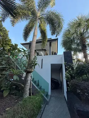 a palm tree in front of a house with a palm tree at Luxury Pool Villa Near Laguna - Gym, Jacuzzi & Cinema in Phuket