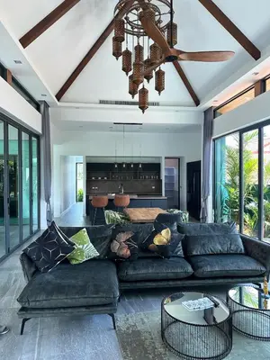 a living room with a couch and a ceiling fan at Luxury Pool Villa Near Laguna - Gym, Jacuzzi & Cinema in Phuket