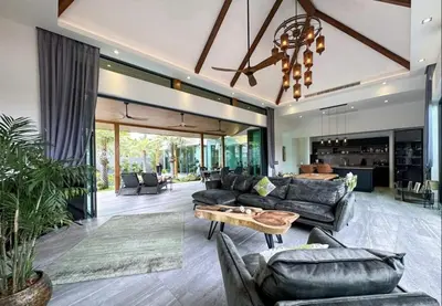a living room with couches and a table at Luxury Pool Villa Near Laguna - Gym, Jacuzzi & Cinema in Phuket