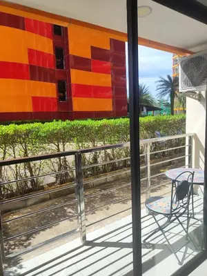 a table and a chair on a balcony at Уютная студия в жилом комплексе в заповедном уголке Пхукета in Ban Mai Salae