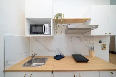 a kitchen with a sink and a microwave at 2Rooms apartment in Bangla Patong in Patong Beach