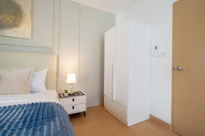 a white bedroom with a bed and a white closet at 2Rooms apartment in Bangla Patong in Patong Beach
