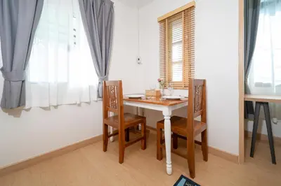 a dining room with a table and chairs and a window at 2Rooms apartment in Bangla Patong in Patong Beach