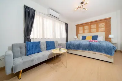 a bedroom with a couch and a bed and a window at 2Rooms apartment in Bangla Patong in Patong Beach