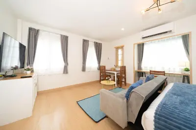 a bedroom with a bed and a couch and a tv at 2Rooms apartment in Bangla Patong in Patong Beach
