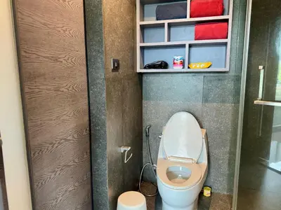 a small bathroom with a toilet in a stall at Room in Kamala at Citygate Condo in Kamala Beach