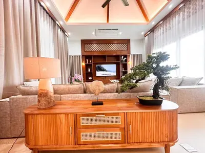 a living room with a couch and a table at La Nissta Villa 4bdr pool Villa Phuket in Koh Lone