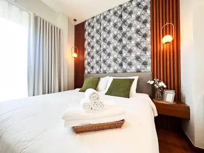 a hotel room with a bed with two towels on it at La Nissta Villa 4bdr pool Villa Phuket in Koh Lone