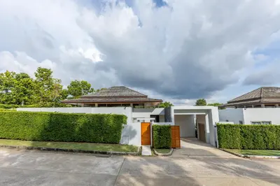 a white house with hedges in front of it at Botanica Foresta x MonthStayZ Thailand in Bang Tao Beach