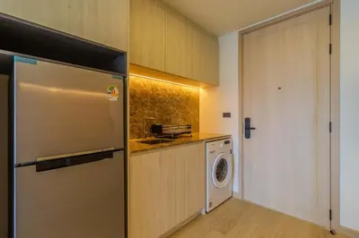 a kitchen with a refrigerator and a washing machine at C240 New Prime Location 1BR Condo Near Beach Club in Thalang