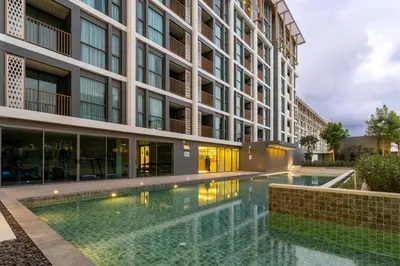 a swimming pool in front of a building at C240 New Prime Location 1BR Condo Near Beach Club in Thalang