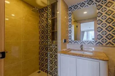 a bathroom with a sink and a mirror at C240 New Prime Location 1BR Condo Near Beach Club in Thalang