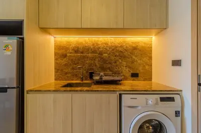 a kitchen with a sink and a washing machine at C240 New Prime Location 1BR Condo Near Beach Club in Thalang