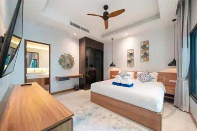 a bedroom with a bed and a bathroom at Nicky Villa Luxury Private Haven in BangTao Laguna in Laguna Phuket
