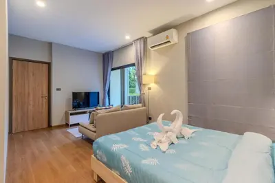 a bedroom with a bed with a stuffed animal on it at C241 2BR Pool Access 5 Min Walk to Rawai Beach in Rawai Beach