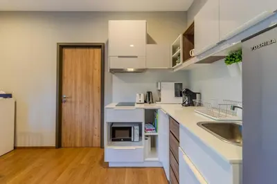 a kitchen with a sink and a counter with a microwave at C241 2BR Pool Access 5 Min Walk to Rawai Beach in Rawai Beach