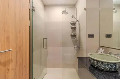 a bathroom with a sink and a glass shower at C241 2BR Pool Access 5 Min Walk to Rawai Beach in Rawai Beach