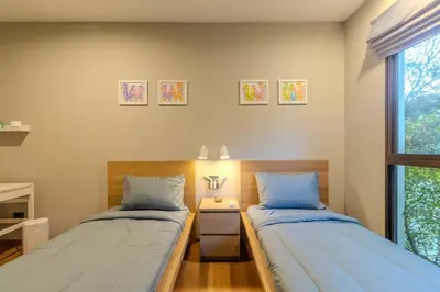 two twin beds in a room with a window at C241 2BR Pool Access 5 Min Walk to Rawai Beach in Rawai Beach