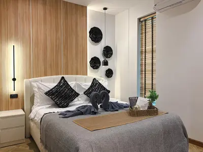 a bedroom with a bed with a tray on it at The Eden Hill in Phuket Town