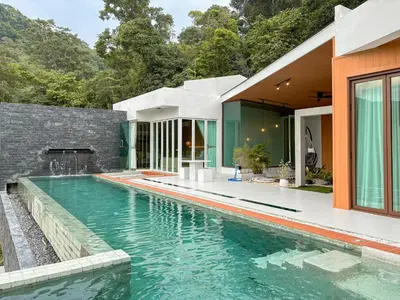 an external view of a house with a swimming pool at The Eden Hill in Phuket Town