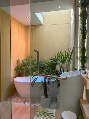 a bathroom with a tub with plants in it at The Eden Hill in Phuket Town