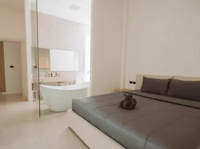 a bedroom with a bed and a bathtub and a bath tub at Вилла в поселке БанБуа in Rawai Beach