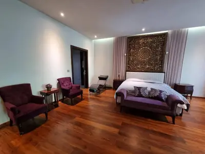 a bedroom with a bed and two chairs at Luxury Villa with Panoramic Seaview, Private Pool in Ban Saiyuan (1)