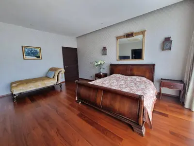 a bedroom with a bed and a couch and a mirror at Luxury Villa with Panoramic Seaview, Private Pool in Ban Saiyuan (1)