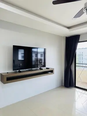 a living room with a flat screen tv on a wall at Patong Elite Condo Nanai, Patong, Phuket in Patong Beach