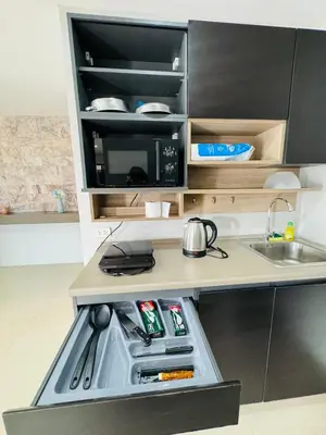 a small kitchen with a stove and a sink at Patong Elite Condo Nanai, Patong, Phuket in Patong Beach