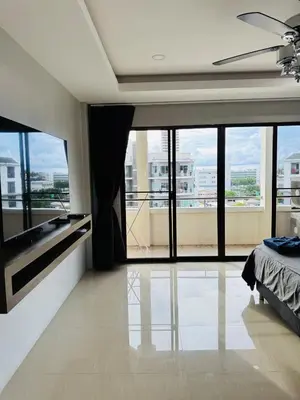 a bedroom with a large window with a view of a building at Patong Elite Condo Nanai, Patong, Phuket in Patong Beach