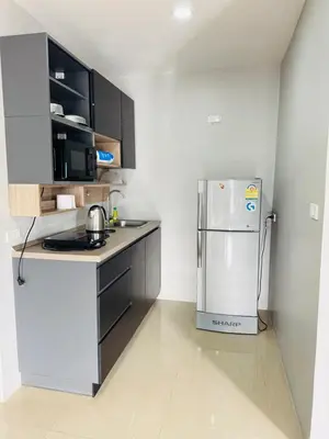 a small kitchen with a refrigerator in a room at Patong Elite Condo Nanai, Patong, Phuket in Patong Beach