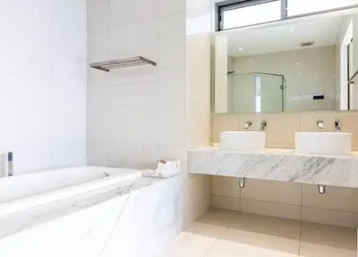 a bathroom with two sinks and a tub and a mirror at Luxury Penthouse with Private Pool at View Phuket F9 in Karon Beach