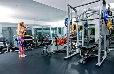 a woman standing in a gym with a gym equipment at Luxury Penthouse with Private Pool at View Phuket F9 in Karon Beach