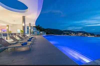 a hotel swimming pool at night with a view at Luxury Penthouse with Private Pool at View Phuket F9 in Karon Beach