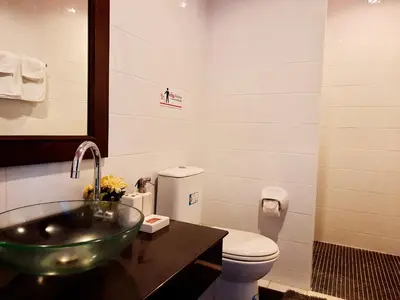 a bathroom with a sink and a toilet at Purimas Resortel in Rawai Beach